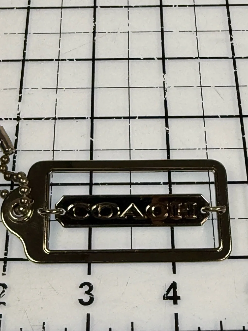 Coach gold tone